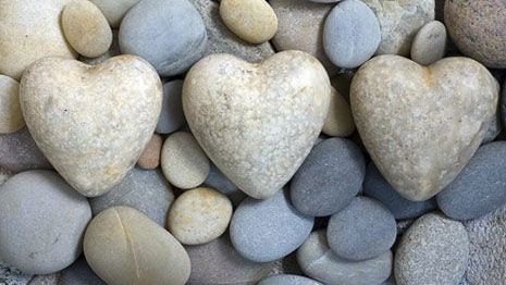 Three heart shaped stones on a beach